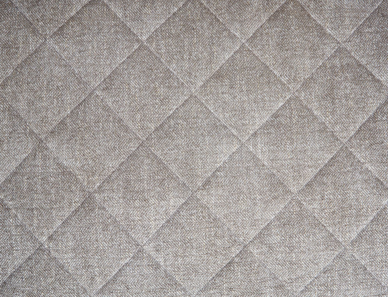 A close-up of soft grey quilted fabric on an Orvis Dog Bed.