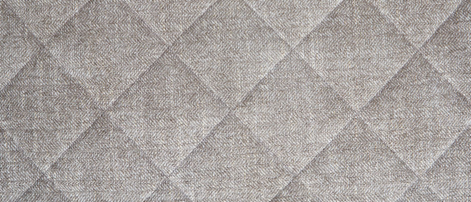 A close-up of soft grey quilted fabric on an Orvis Dog Bed.