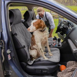 A dog sitting on a Grip-Tight® Quilted Bucket Seat Protector