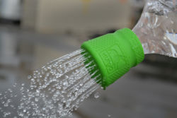 A green shower attachment that goes onto a water bottle