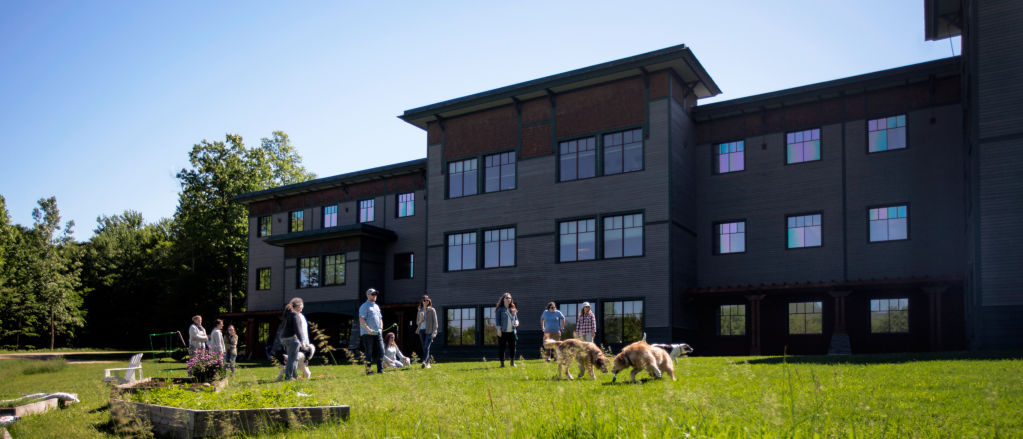 Orvis employees and their dogs in front of the Orvis corporate headquarters in Sunderland, Vermont