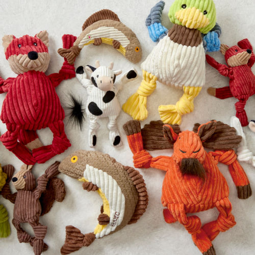 A dog toy collection of fuzzy stuffed animals.