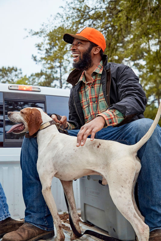 Durrell smiling with his hunting dog