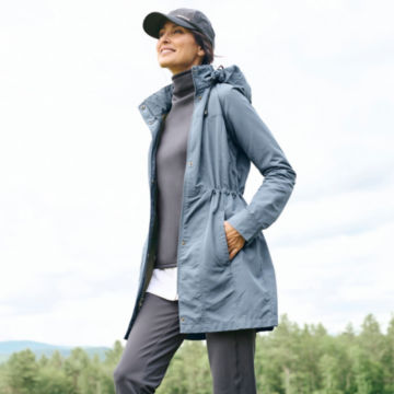 Woman in Bluestone Pack-and-Go Jacket goes for a walk outdoors.