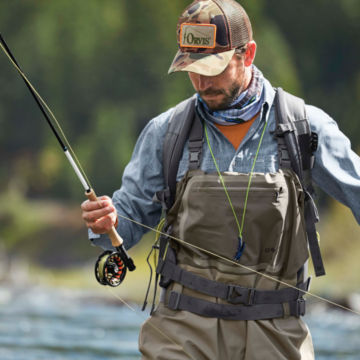 Angler adjusts his line with nippers around his neck.