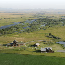 An aerial view of ranch next to a river.