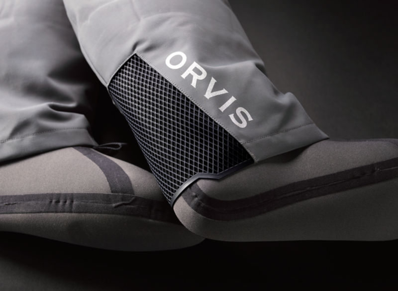 A detail shot of Orvis PRO Waders neoprene bootie and the mesh gravel guard behind the heel.