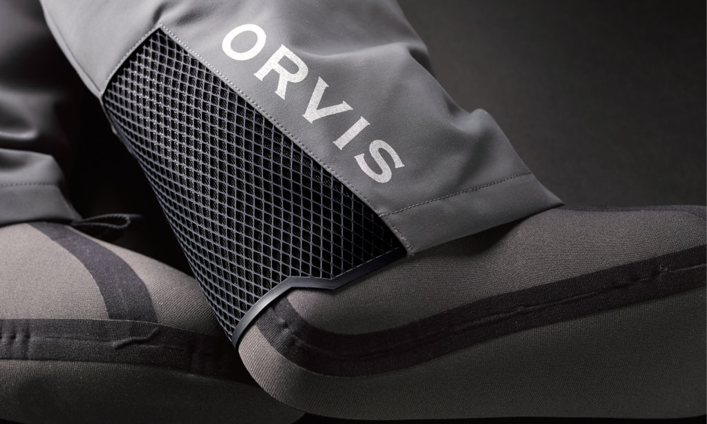 A detail shot of Orvis PRO Waders neoprene booties and the mesh gravel guard behind the heel.