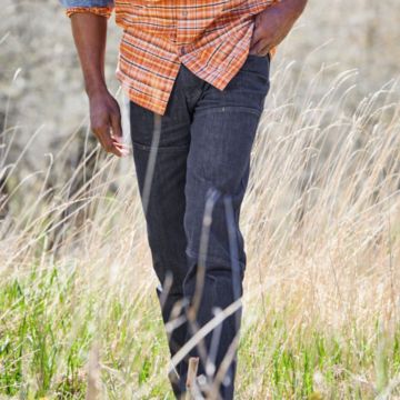 Man walks through field in CORDURA® Tech 5-Pocket Denim.