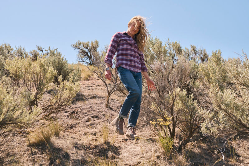 A woman walking down a hill in the Southwest USA.