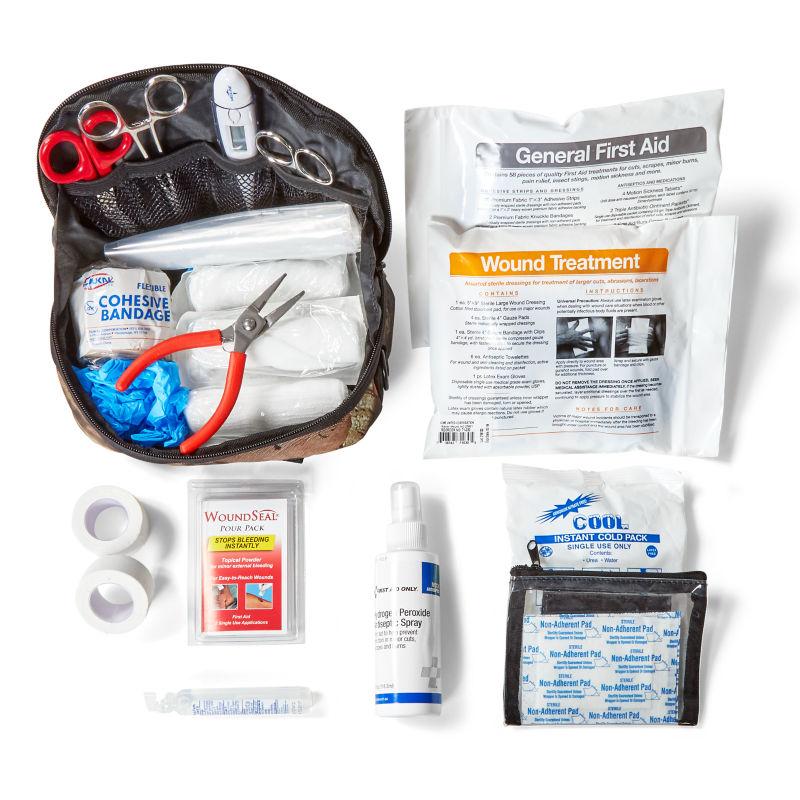 A dog first aid kit and safety gear knolled on a white background.