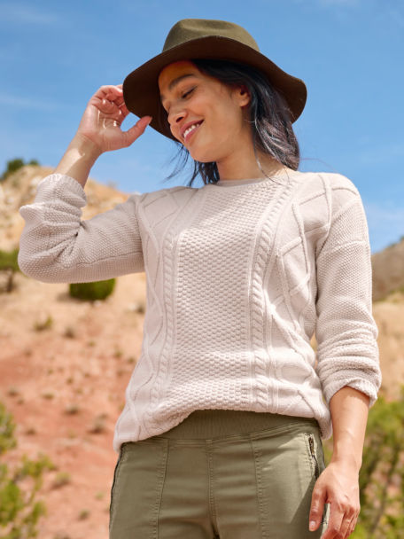 Woman in Cotton Cable Crew Sweater walks through the desert.