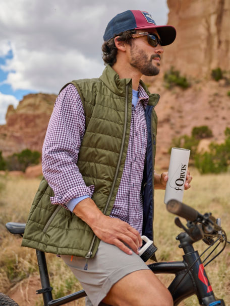 Man bikes through desert and drinks from an Orvis Miir Cantine