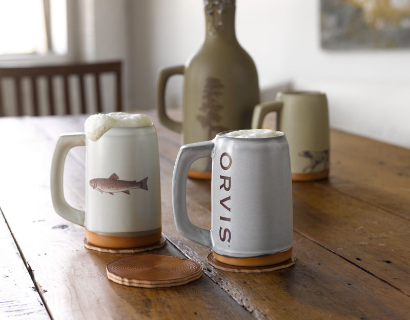 Ceramic mugs, steins, and growlers with Orvis art and logos.