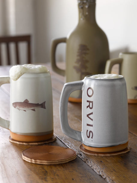 Ceramic mugs, steins, and growlers with Orvis art and logos.