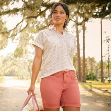 Woman in Easy Printed Camp Shirt and Everyday Chino Short walks through a park.
