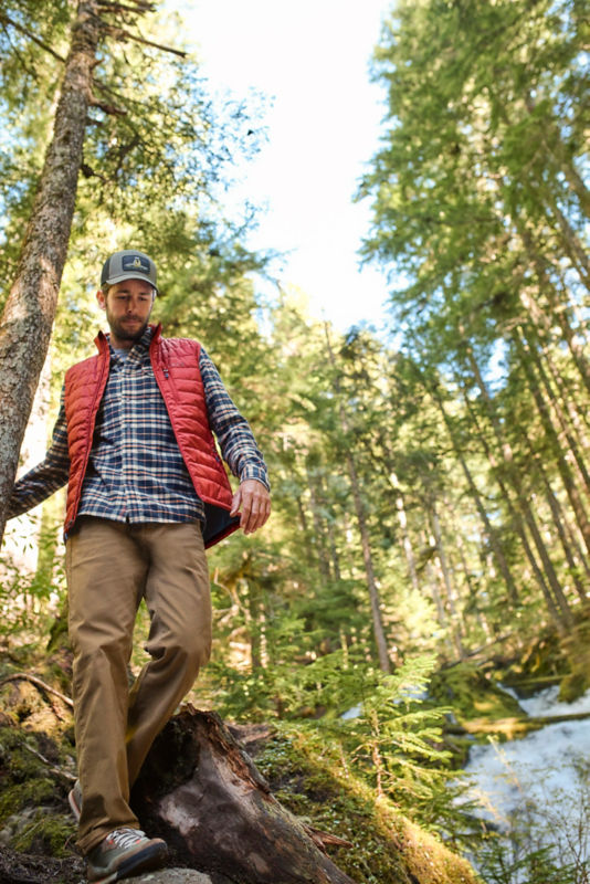 A man hiking down a hill in the woods