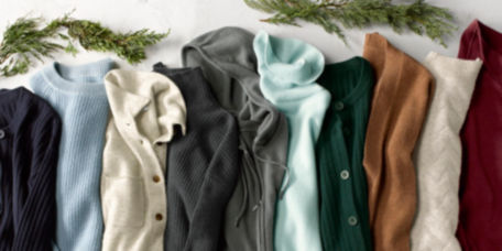 A close up of a variety of colors and styles of cashmere sweaters