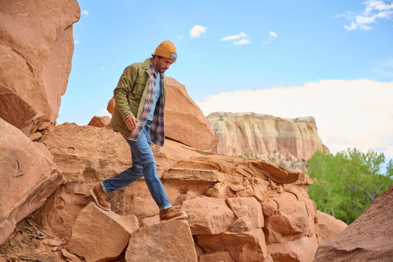 Man walking down canyon trail.