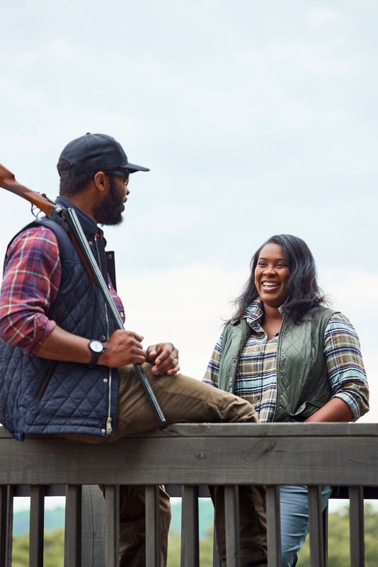Ashley and Durrell Smith standing and talking to each other at a shooting stand