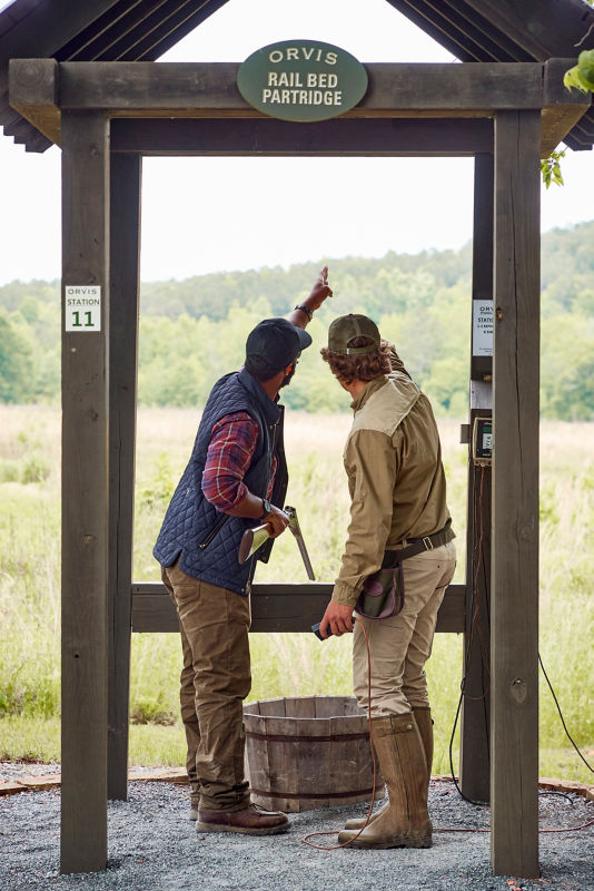 Two people discussing conditions at a shooting stand