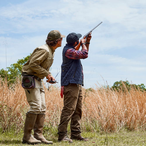 A instructor guides a hunter in shooting technique