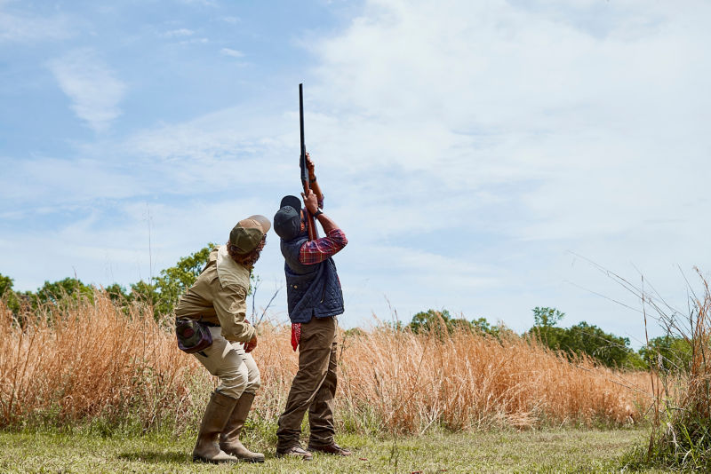 An instructor giving shooting lessons to a student