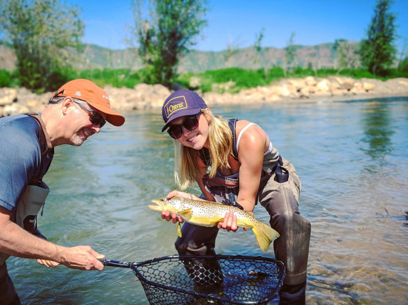 Two women fishing a river