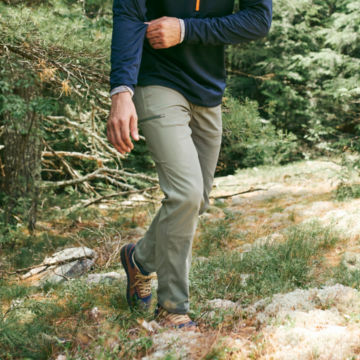 Man in Juniper G.S.D. Pants walks through the woods.