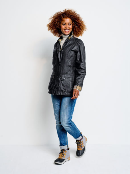 Woman in Navy Barbour® Beadnell Jacket poses for a photo in studio.