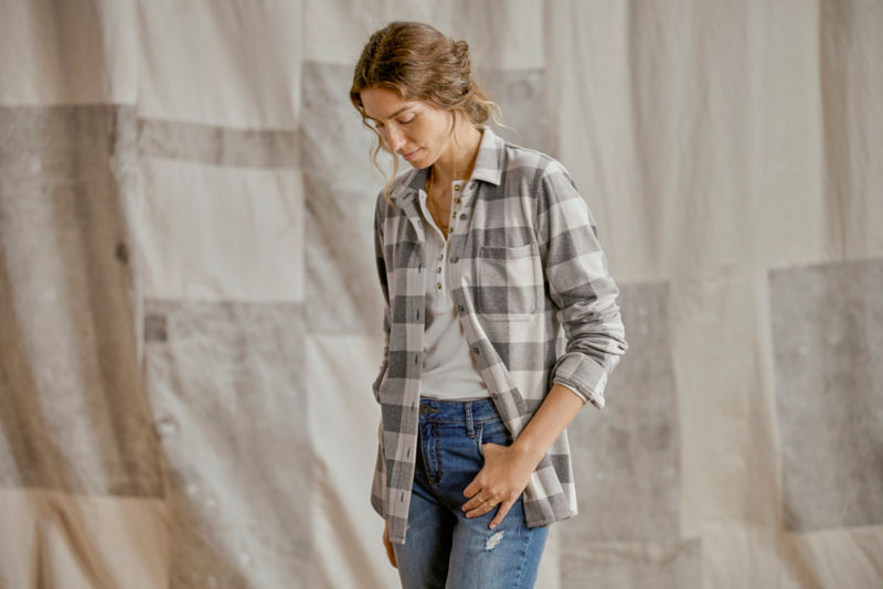 Model wearing gray plaid flannel with jeans