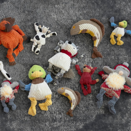 A dog toy collection of fuzzy stuffed animals.