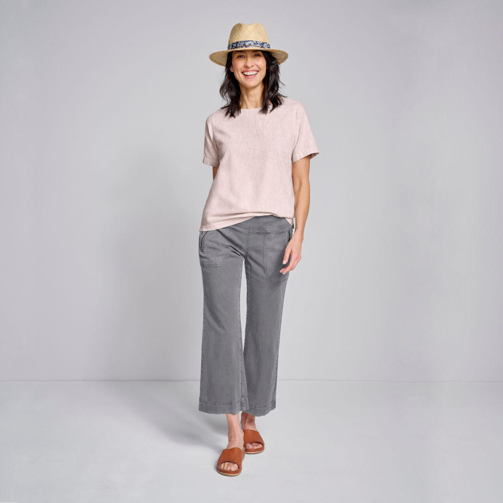 Model wearing It’s-A-Balance Short-Sleeved Popover in sandcastle, Explorer Natural Fit Wide-Leg Cropped Pants in storm, Sonoma Straw Hat, and Kork-Ease® Tutsi Slides in brown.