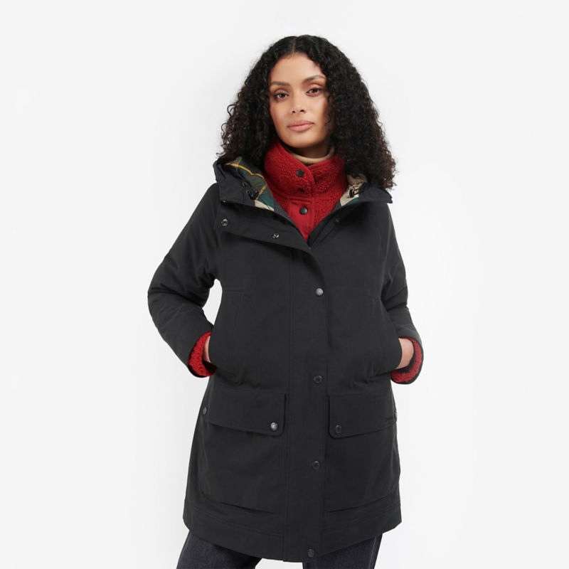 Model in black jacket with red sweater