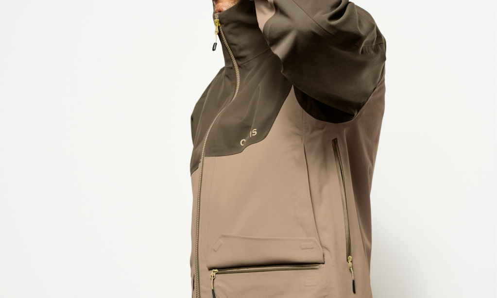 A person in the ToughShell Jacket lifts their arm to show the underarm zipper.