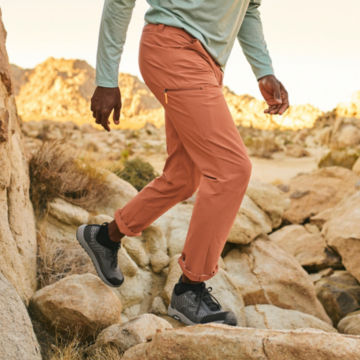 Man in Canyon Jackson Quick-Dry Pants walks down a desert trail.