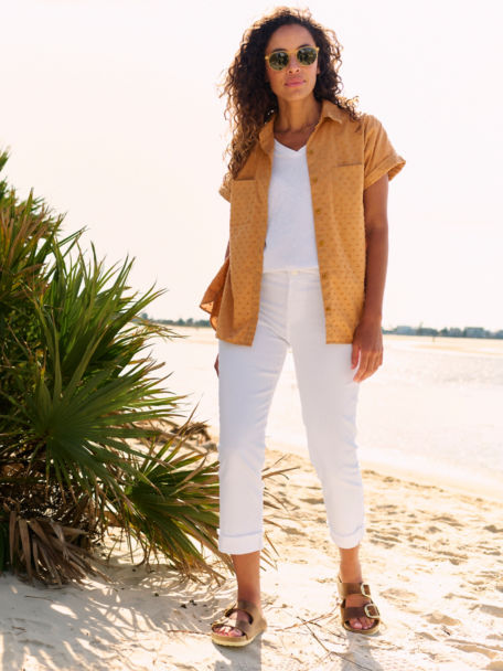 Woman wearing white jeans on the beach