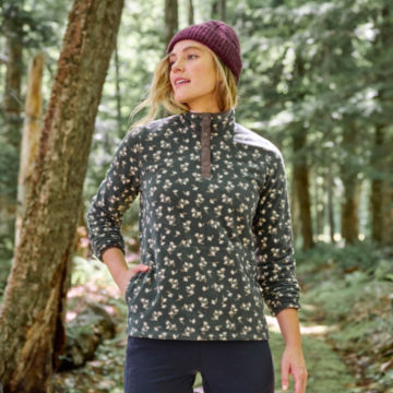 Woman in Hill Country Microfleece Quarter-Snap walks through the woods.