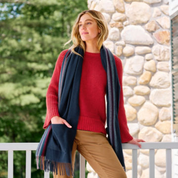 Woman in Paprika Plaited Rib Detail Sweater leans on her porch.