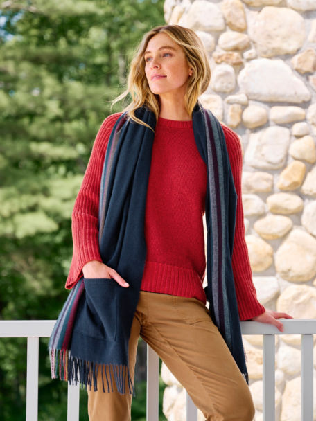 Woman in Red Plaited Rib Detail Sweater stands on her porch.