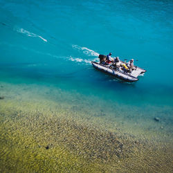 An aerial shot of a fishing boat over blue waters
