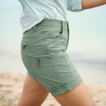 Woman in Jackson Quick Dry Shorts walks along a beach.