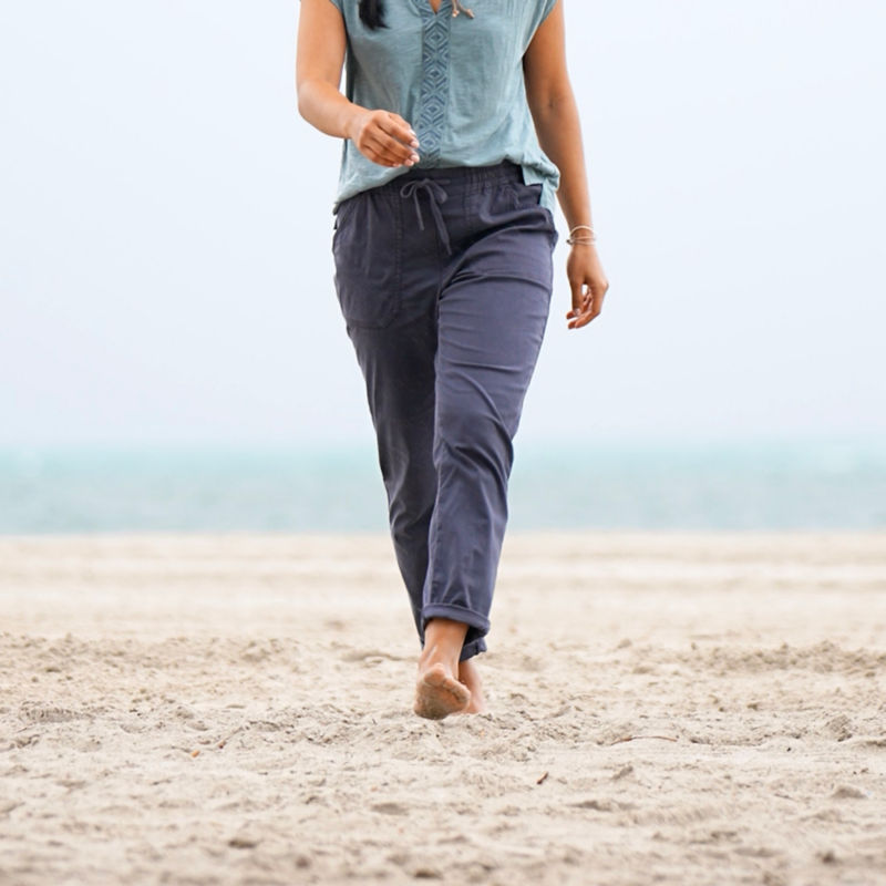 Woman in Explorer Ankle Pants walks down a beach. image number 4