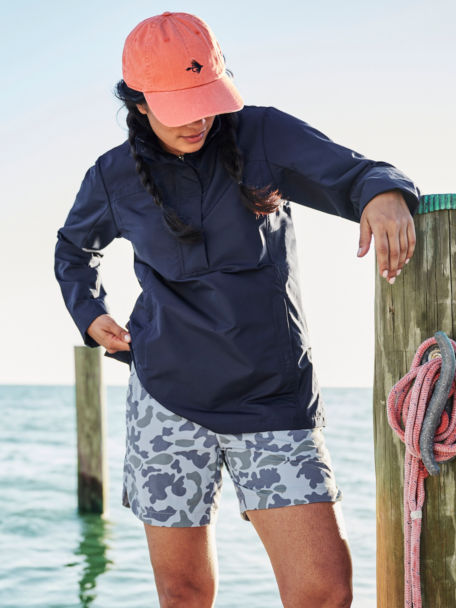 Woman in navy anorak standing on a dock