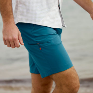 Man in Jackson Quick-Dry Shorts walks down a beach.
