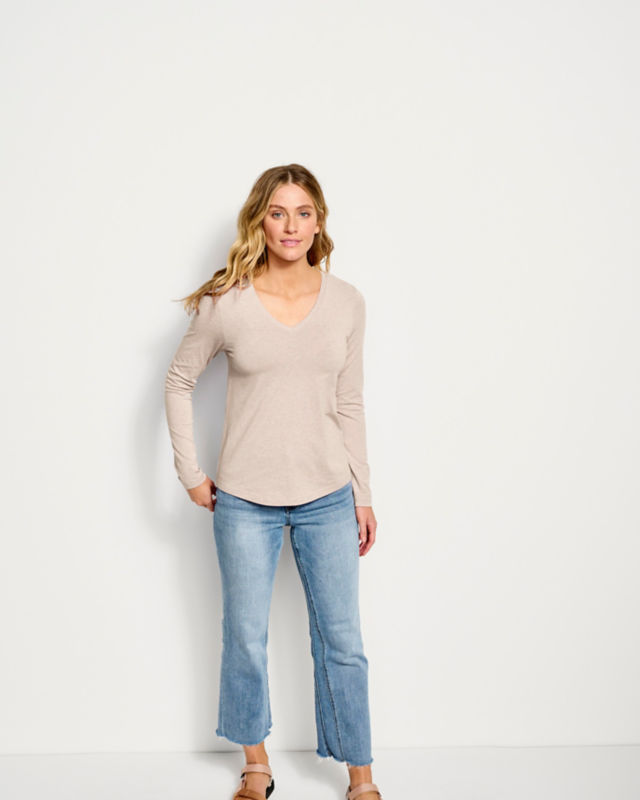 Model wearing cream shirt and jeans