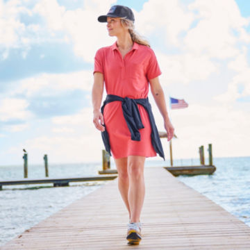 Woman in Perfect Polo Dress walks up a pier.