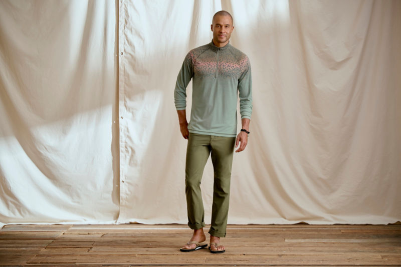 Man wearing fish print quarter-zip in a studio.