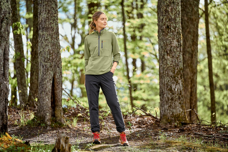 Model wearing green horseshoe hills 1/4 zip with black pants