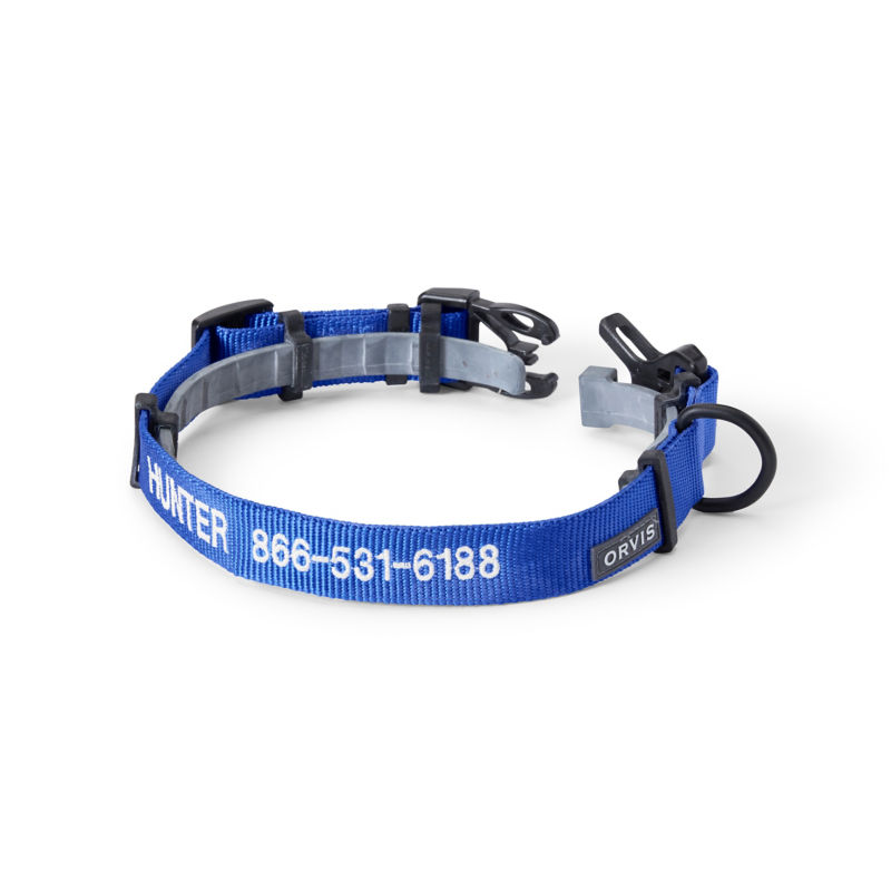 A blue personalized dog collar with the name Spaulding embroidered on it.